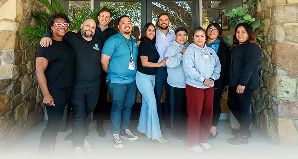 Staff outside front of facility